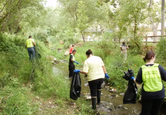 Community volunteers participate in a creek clean-up