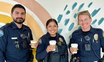 Officers holding coffee cups