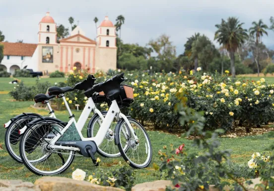 Two electric-assist bicycles at the Rose Garden at the Santa Barbara Mission.