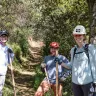 Three trail restoration volunteers smiling