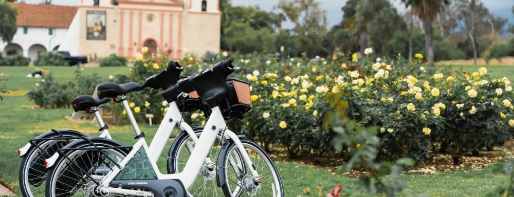 Two electric-assist bicycles at the Rose Garden at the Santa Barbara Mission.