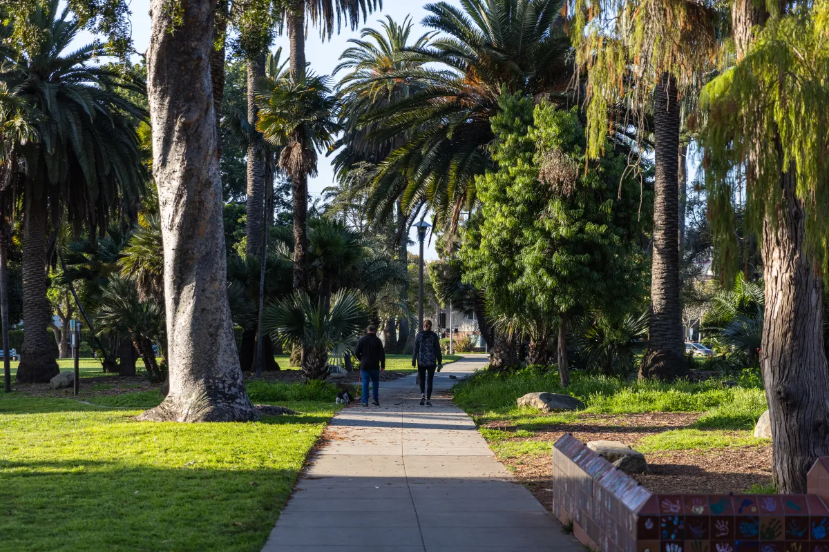 Park users walking their dog through Alameda Park